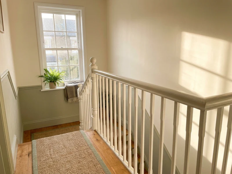 Sunlit, freshly cleaned staircase and landing in a Repton home